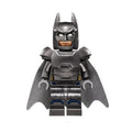 Minifigure of a superhero in an armored suit with a gray color scheme and a cape, showcasing detailed armor design.