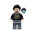 Tony Stark minifigure with dark hair, black graphic shirt, gray pants, and an alternate headpiece with a different expression.