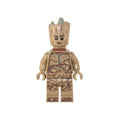 Minifigure resembling a tree-like character with a light brown body, expressive face, and green tips on top.