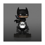Batman from Arkham Knight Funko Pop Deluxe figure standing on a spotlight base with a bat symbol, featuring a serious expression.