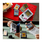 Handheld gaming device resembling a Game Boy with a gray body, displaying game graphics and visible game cartridges.