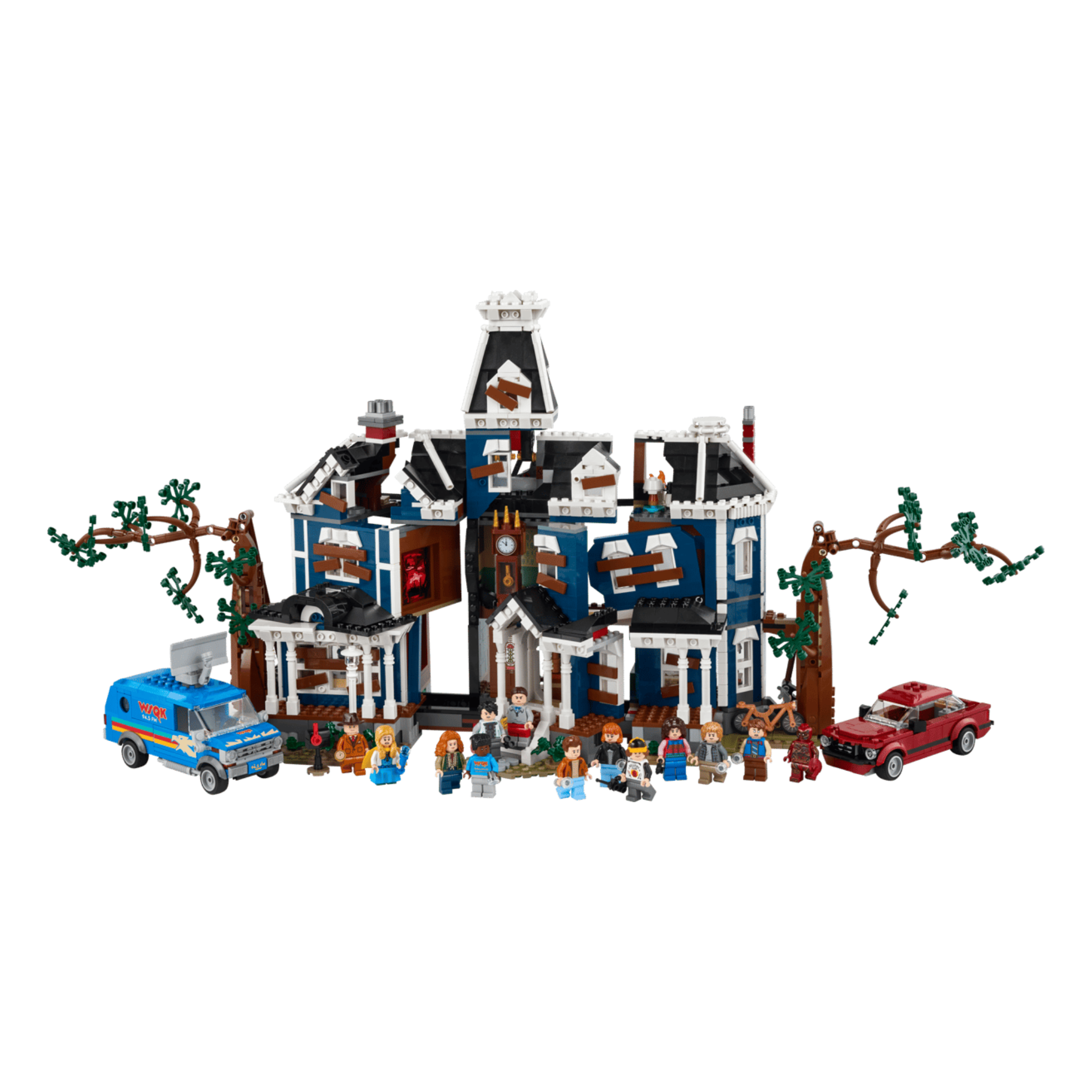LEGO set featuring a blue house with white trim, minifigures, a red car, and a blue van surrounded by trees.