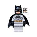 Batman minifigure with a black cape, gray body, and bat emblem, featuring a black mask and alternate facial expression.