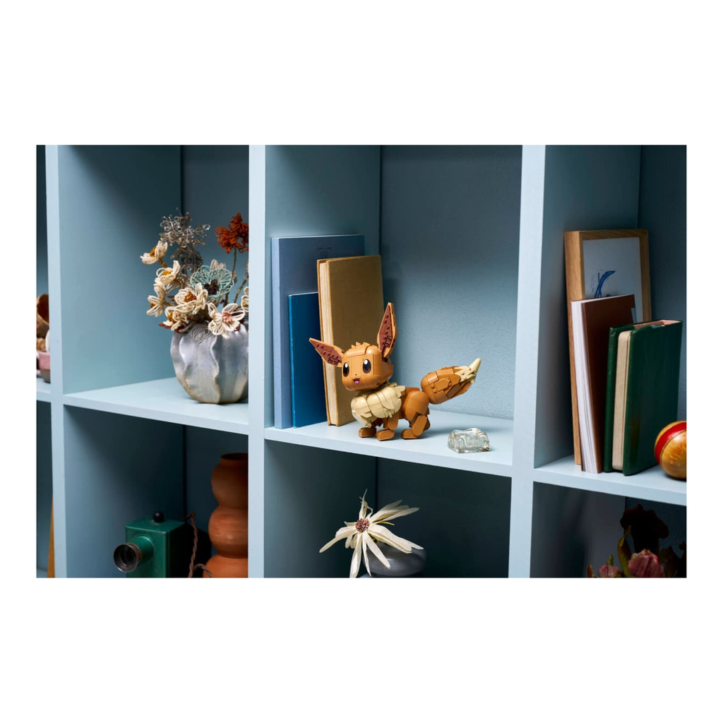 LEGO figure resembling a character with large ears and a bushy tail, displayed on a light blue shelf among decorative items.